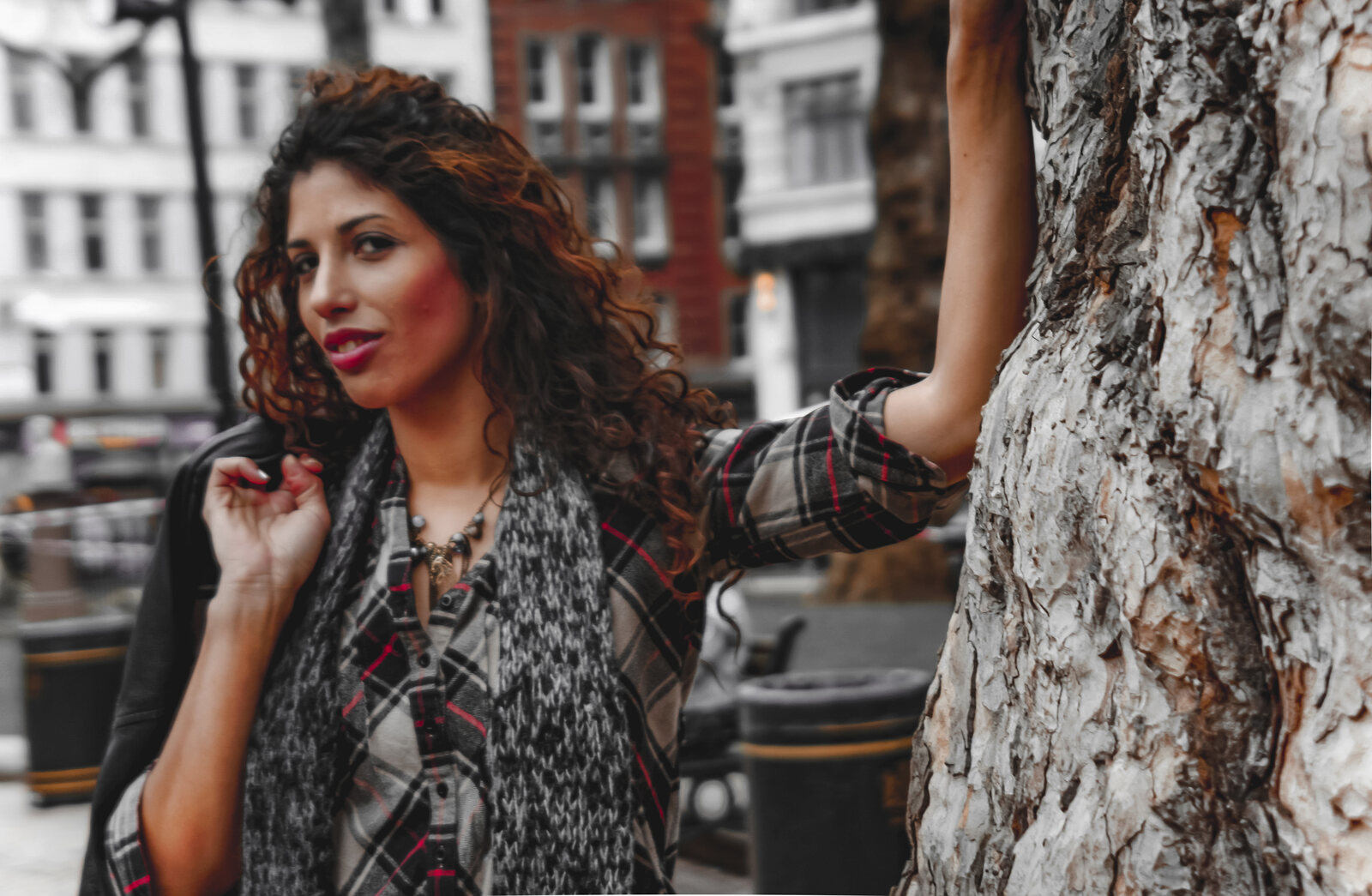 Editorial street portrait of a model against a city square